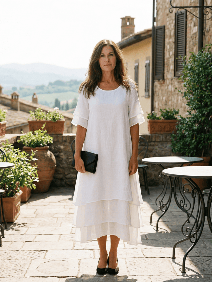 Soft layered Belen™ dress by Emma & Rose Cape Town, featuring flowing fabric and elegant design, displayed on a mannequin.