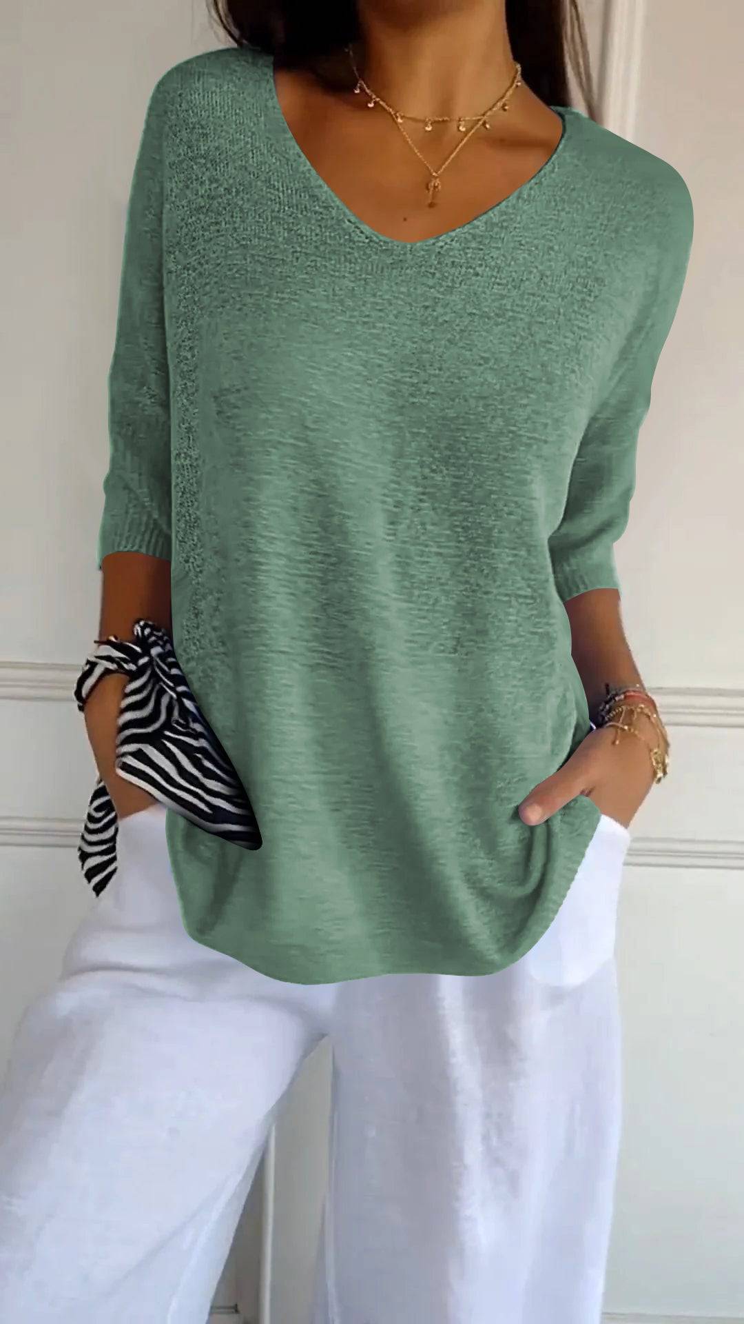 Emma & Rose Durban Jill™ Timeless V-neck Top in soft fabric, shown on a hanger with a neutral background.