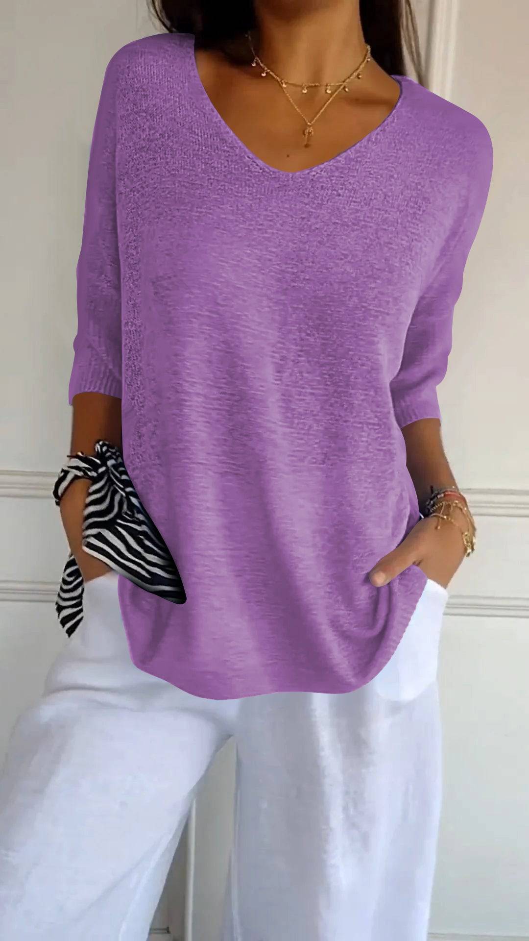 Emma & Rose Durban Jill™ Timeless V-neck Top in soft fabric, shown on a hanger with a close-up of the neckline and fabric texture.