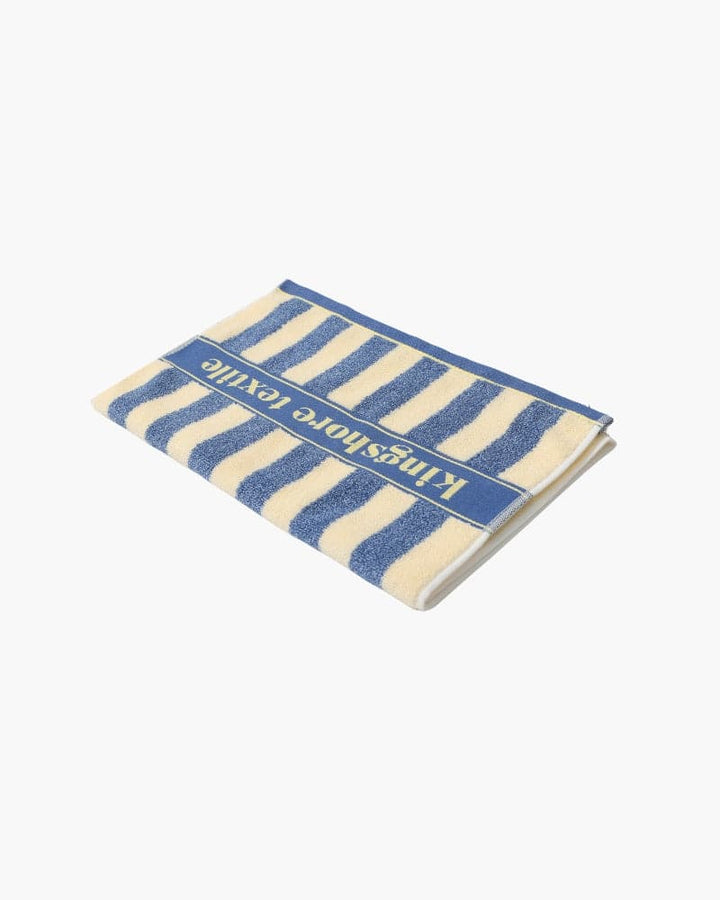 Emma & Rose Manhattan Lance™ Sea Stripe Hand Towel featuring blue and white striped fabric, soft and absorbent for bathroom use.