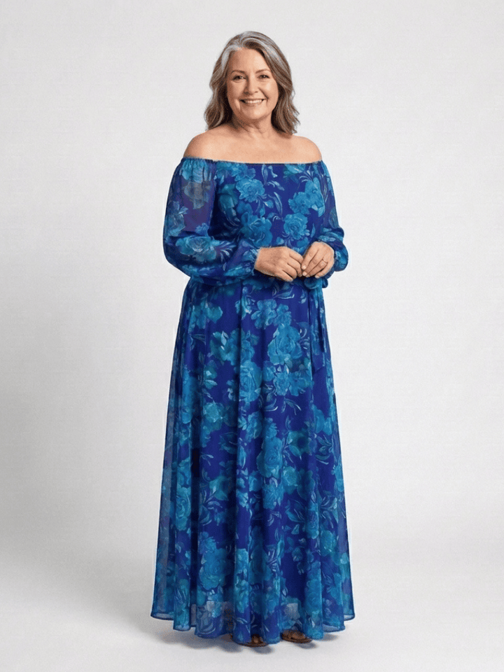 Emma & Rose Cape Town Aspen™ shoulder floral maxi dress with a flowing silhouette and vibrant floral pattern.