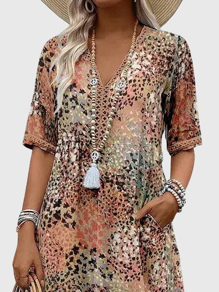 Elegant floral midi dress by Emma & Rose Cape Town featuring a fitted bodice and flowing skirt, perfect for summer events.