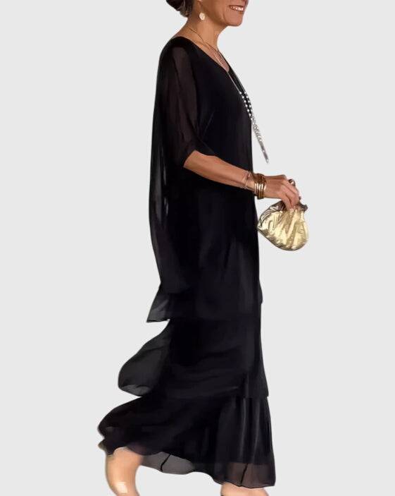 Elegant long flowing dress by Emma & Rose Cape Town, featuring a graceful silhouette and intricate fabric details.