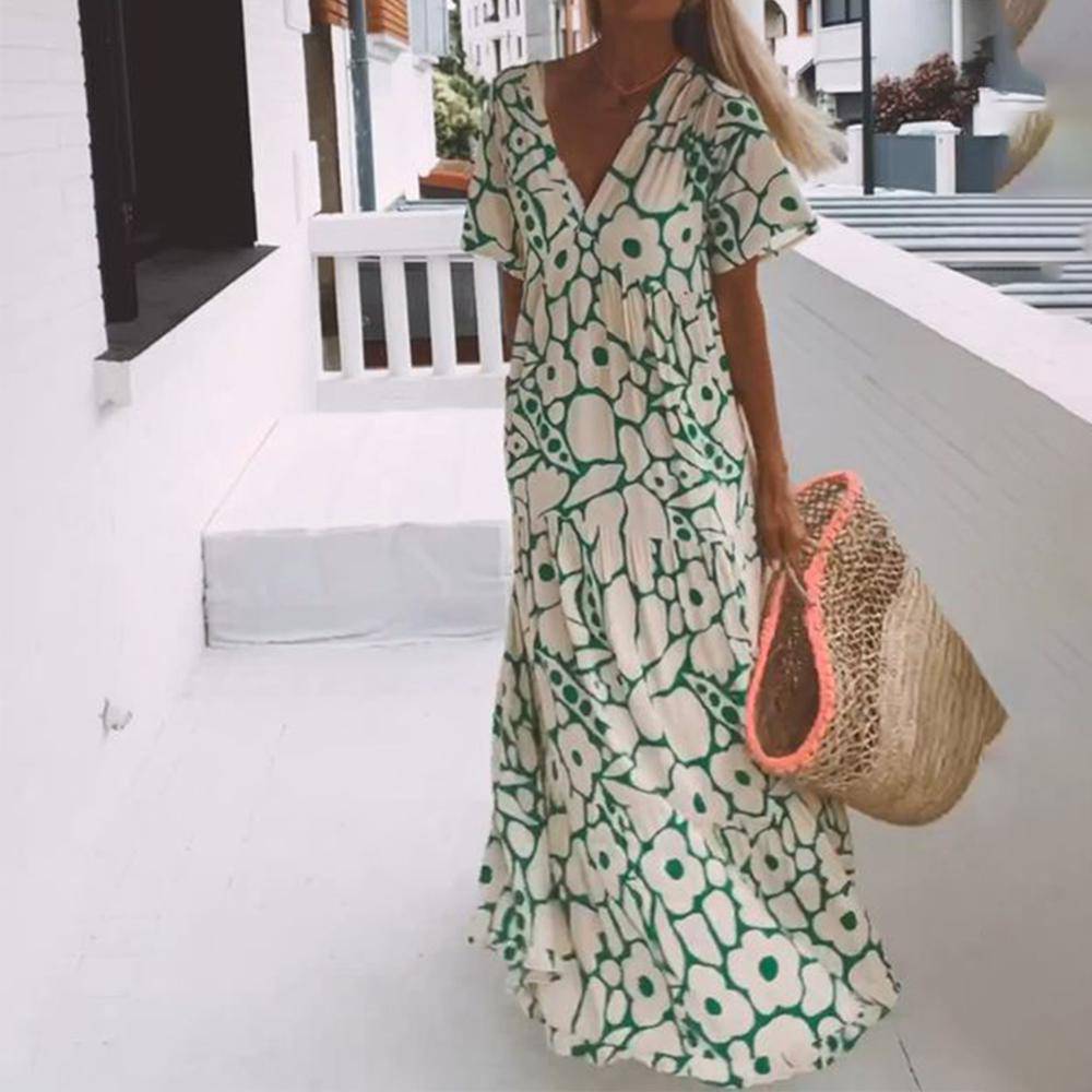 Emma & Rose Manhattan Beatrice™ green maxi dress with flowing fabric and elegant design, showcased on a model.