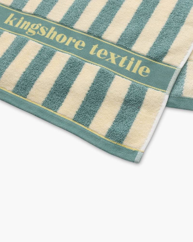 Emma & Rose Manhattan Lance™ Sea Stripe Hand Towel featuring navy and white striped fabric, soft cotton material, hanging on a hook.