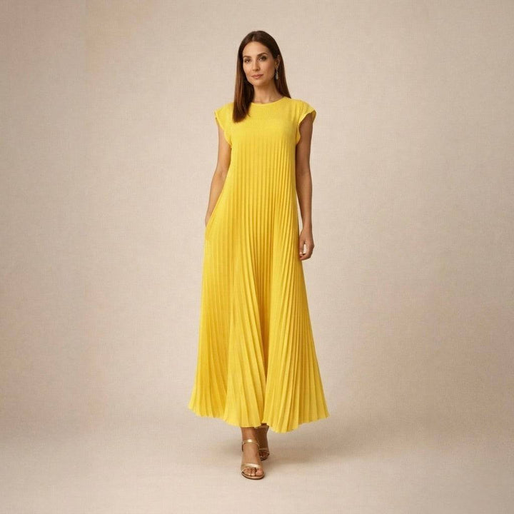 Emma & Rose Cape Town Marianne™ pleated midi dress with flowing fabric and elegant design, shown on a model.