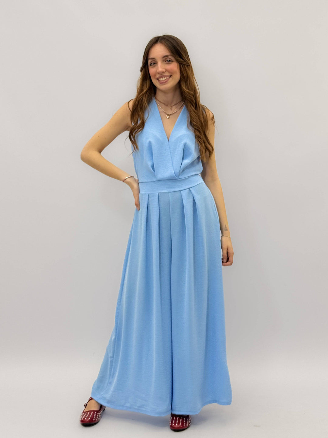 Lightweight™ wide-leg jumpsuit by Emma & Rose Cape Town, featuring a flowing fabric and relaxed fit, displayed on a hanger.