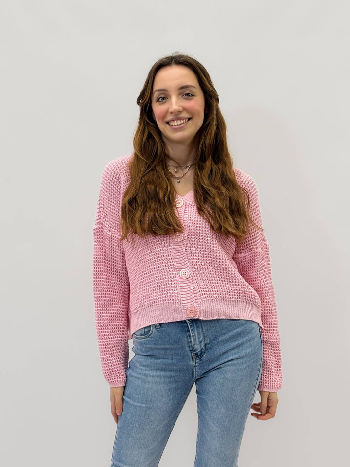 Emma & Rose Cape Town Plain™ Button Cardigan in soft knit maglieria, displayed on a hanger showing its classic design.