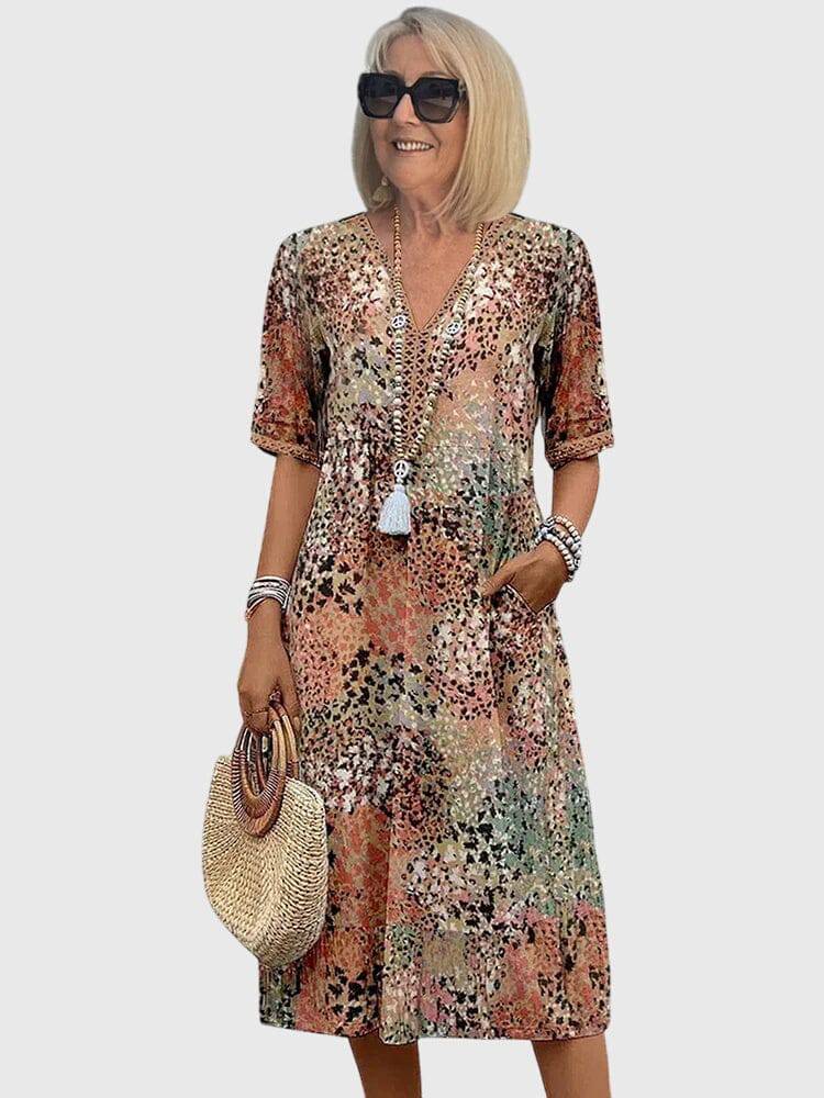 Elegant floral midi dress by Emma & Rose Cape Town featuring a fitted waist and flowing skirt, showcased on a model.