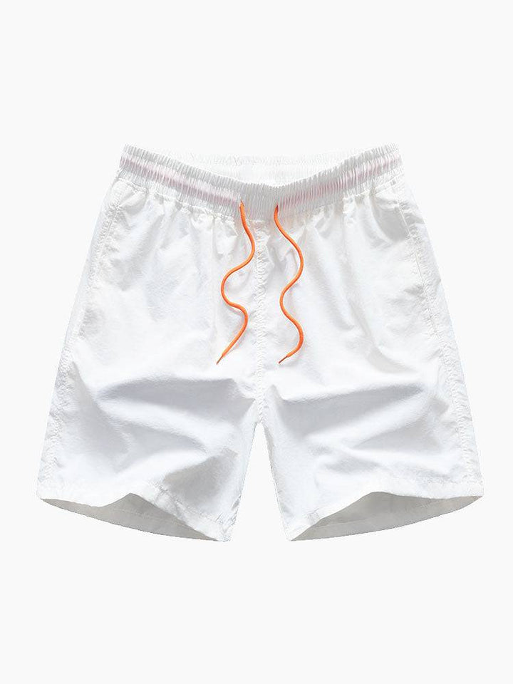 Yorick™ beach swim set by Emma & Rose Manhattan, two-piece swimsuit with colorful patterns worn on a sandy beach.