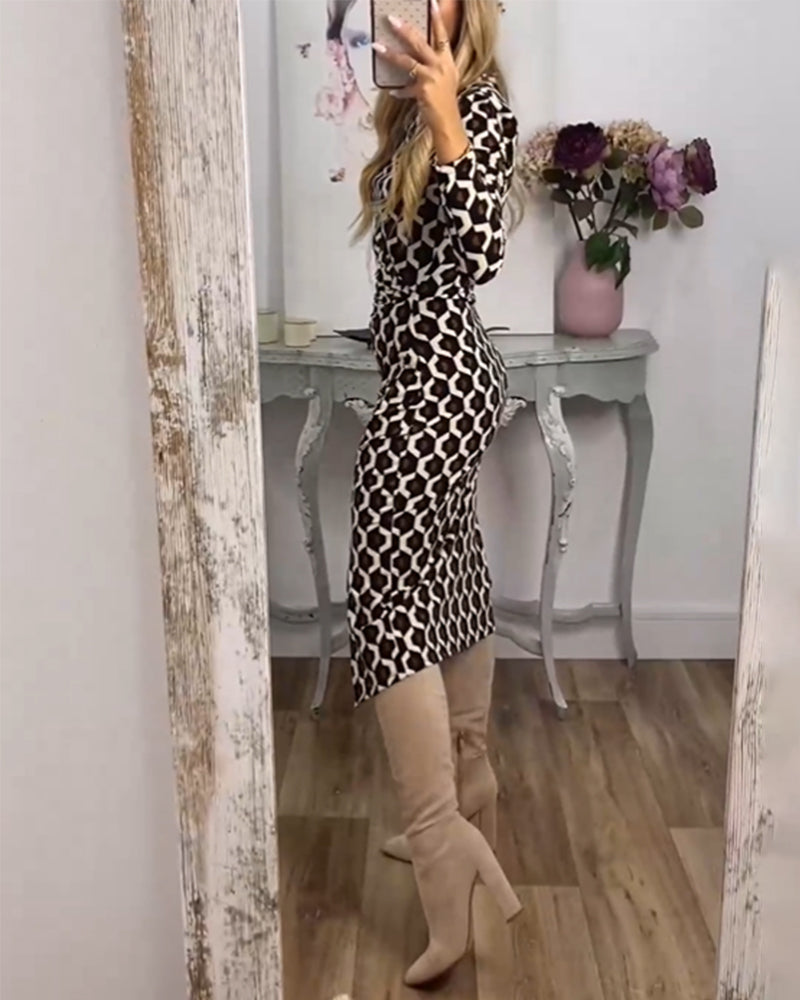 Black dress with a slit and fish scale print by Emma & Rose Cape Town, featuring a fitted silhouette and elegant design.
