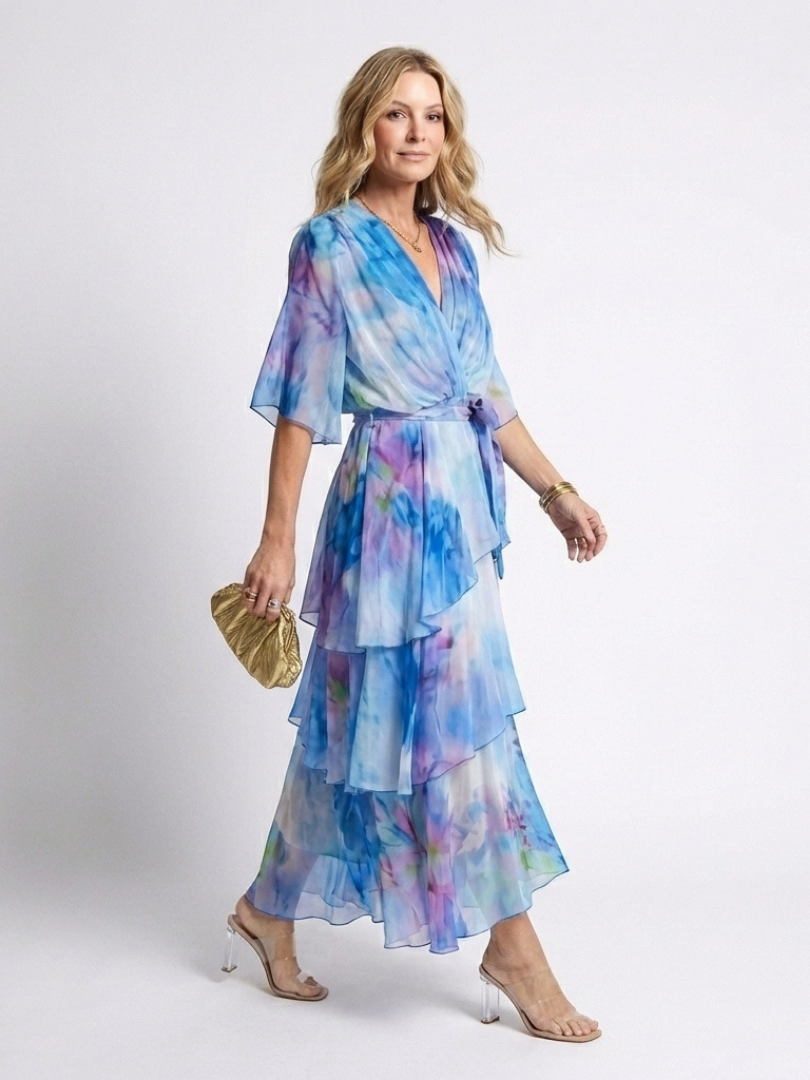 Emma & Rose Cape Town Calista™ sheer layered V-neck dress in blue, featuring flowing fabric and elegant design.