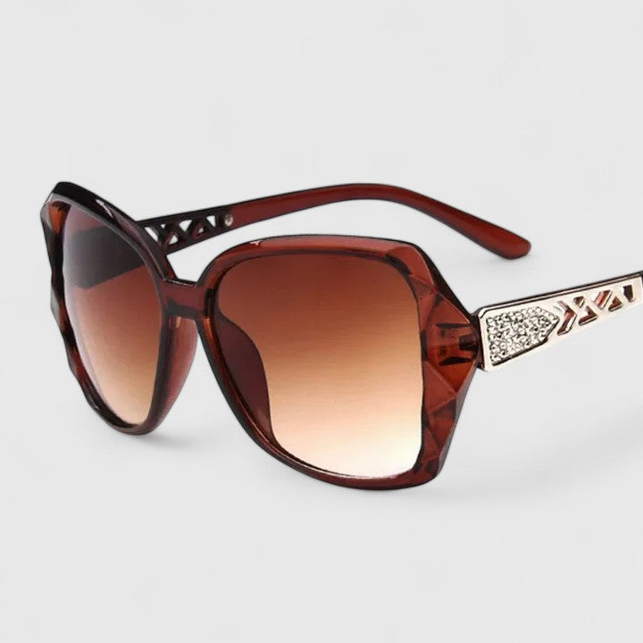 Emma & Rose Cape Town Avalynne sophisticated sunglasses with champagne-colored frames and dark tinted lenses.