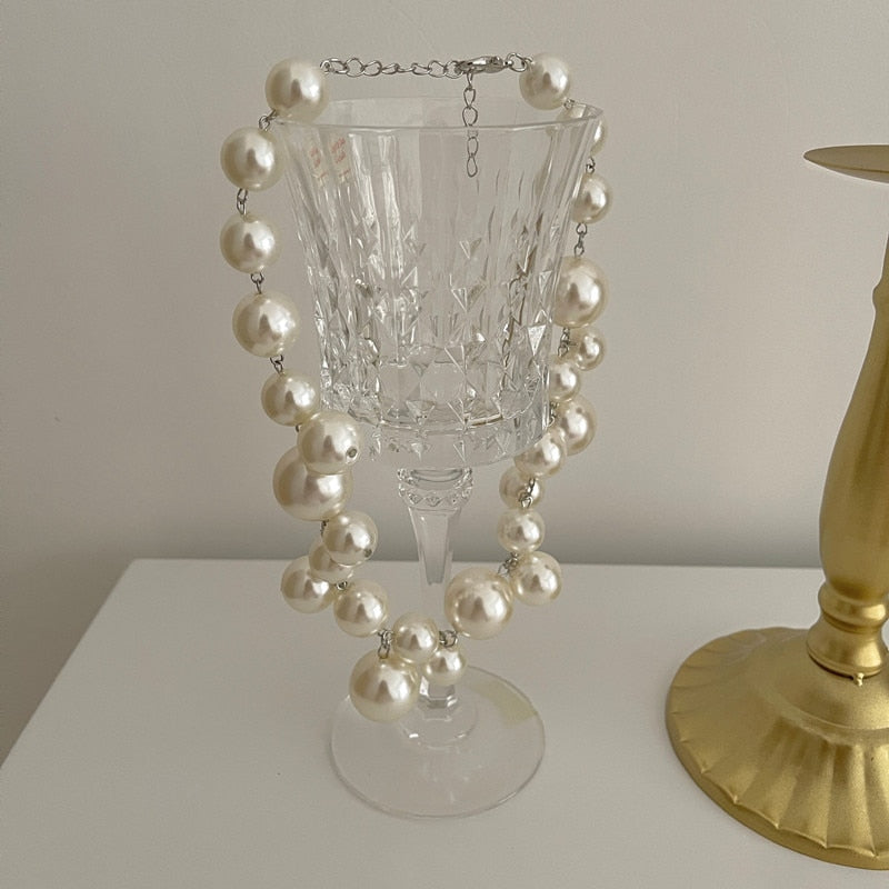 Elegant pearl necklace by Emma & Rose Cape Town featuring a delicate charm on a fine chain.