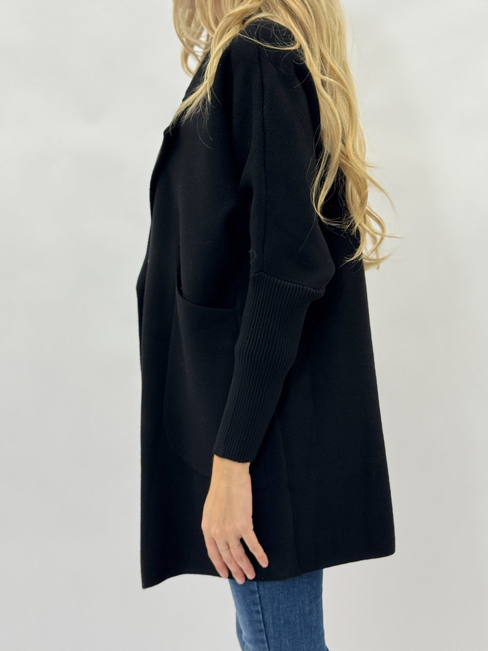 Black Daniëlle™ long knitted cardigan by Emma & Rose Cape Town, shown open with a cozy, textured knit design.