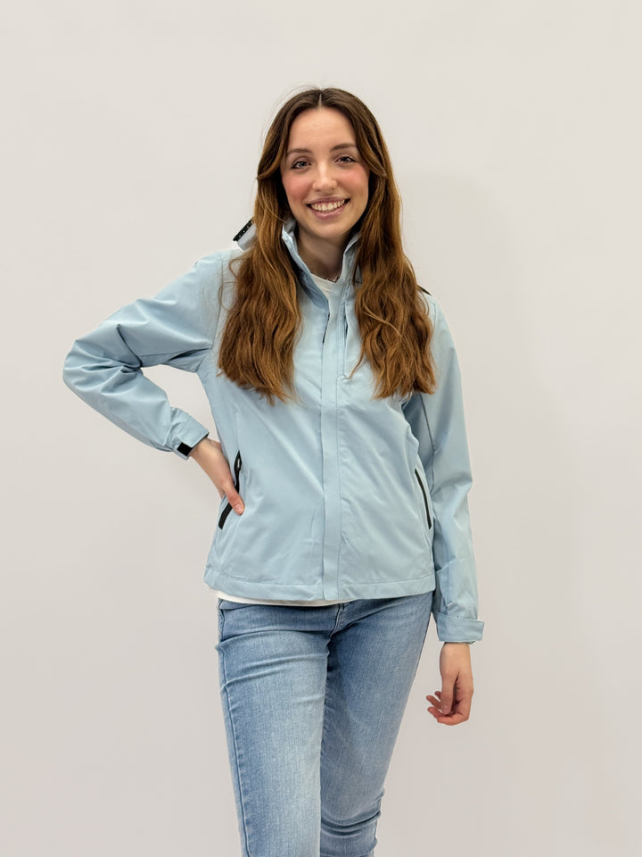 Light blue Nadia™ premium windbreaker jacket by Emma & Rose Cape Town, shown with a sleek, lightweight design and adjustable hood.