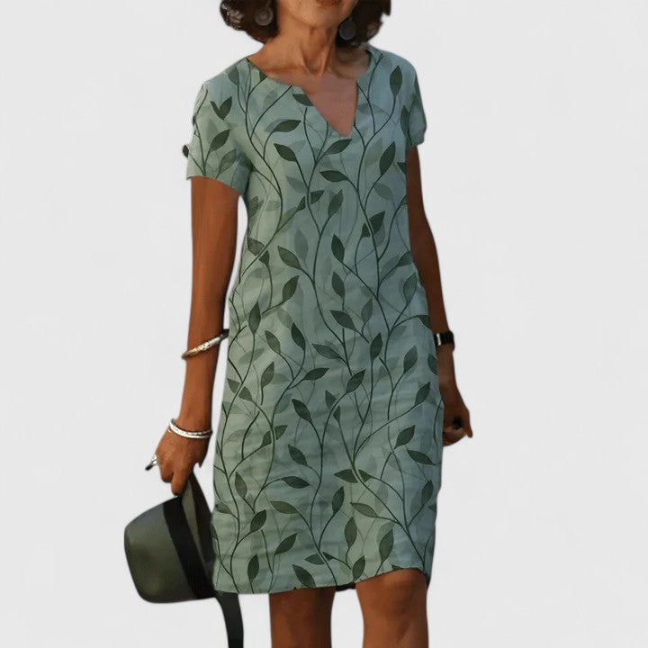 Green Calisse™ elegant summer dress by Emma & Rose Cape Town, lightweight fabric with a flowing silhouette.