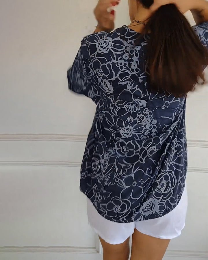 Light blue Rowella™ sophisticated blouse by Emma & Rose Cape Town, shown on a hanger with elegant details and soft fabric.