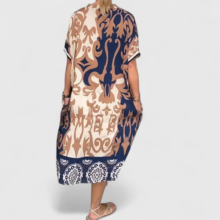 Multi-colored Carvyna™ comfortable dress by Emma & Rose Cape Town, shown on a model, featuring vibrant patterns and relaxed fit.