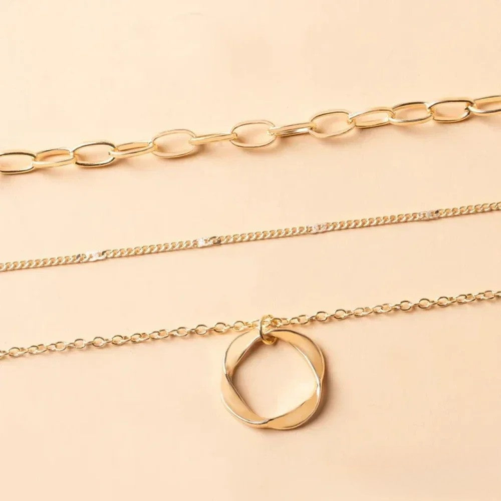 Gold layered necklace by Emma & Rose Cape Town with retro-style design, featuring multiple delicate chains and layered look.
