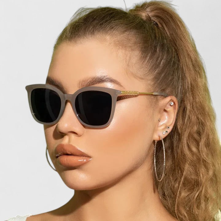 Emma & Rose Cape Town Savanuhh™ stylish sunglasses with white frame and tinted lenses, resting on a white surface.