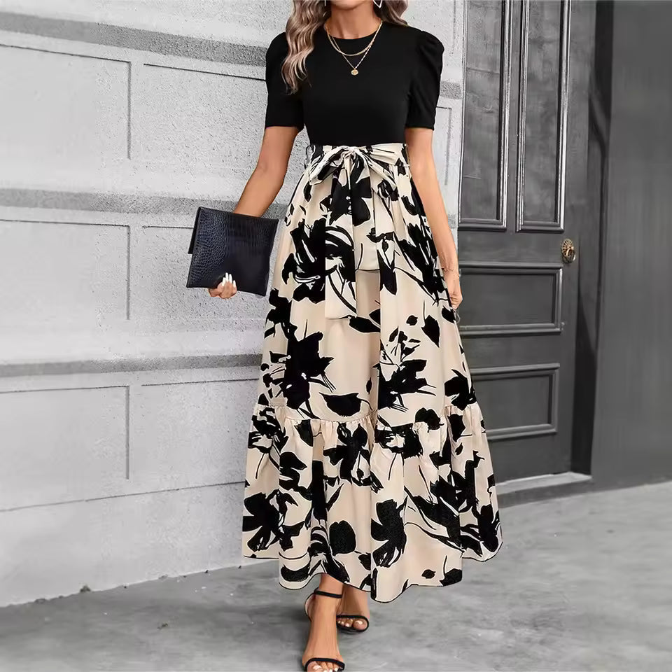 Elegant Ainhoa dress by Emma & Rose Cape Town featuring floral patterns and ruffled details, displayed on a mannequin.