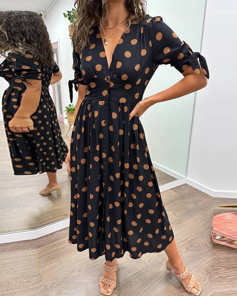 Emma & Rose Manhattan Monique™ elegant polka dot dress with a fitted bodice, short sleeves, and a flowing skirt.