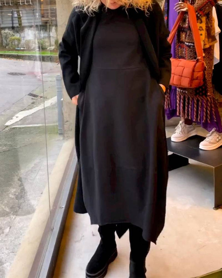Black Clara™ midi dress with pockets by Emma & Rose Manhattan, showcasing a stylish, elegant dress with a fitted waist and mid-length hem.