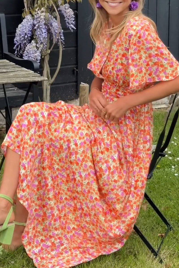 Emma & Rose Manhattan Pauline™ floral long dress with flowing fabric and vibrant flower print, perfect for elegant occasions.