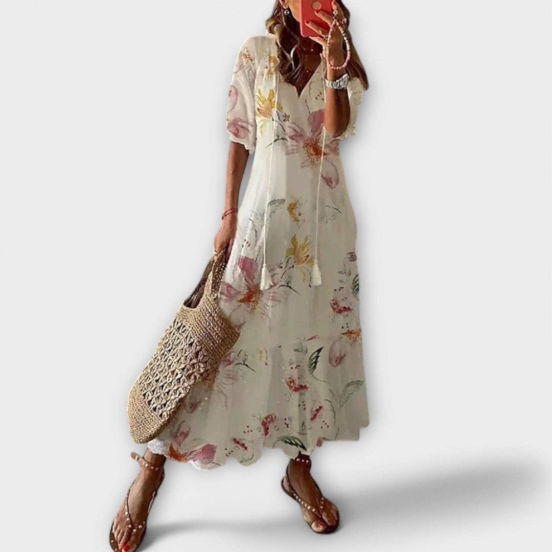 Beige Savannah™ elegant maxi dress by Emma & Rose Cape Town, flowing fabric and fitted bodice, full-length design.