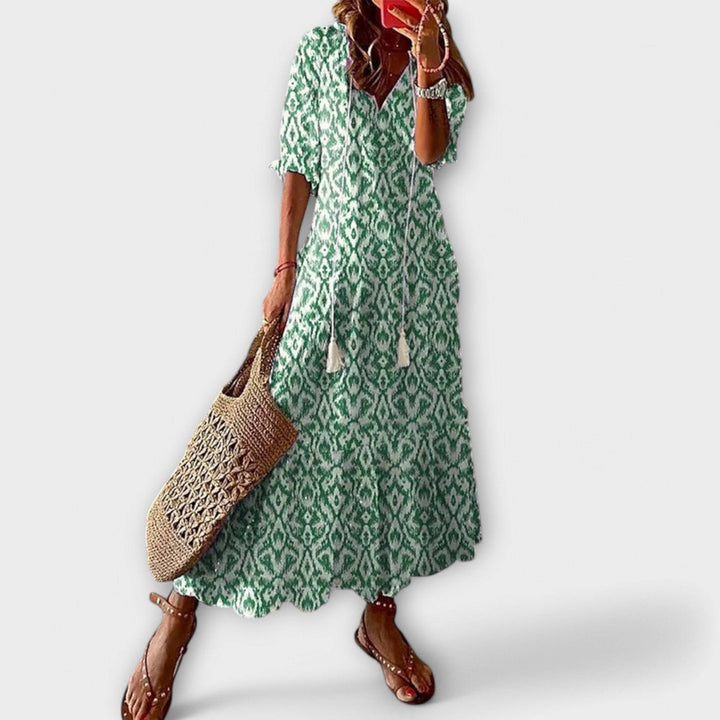 Green Savannah™ elegant maxi dress by Emma & Rose Cape Town, flowing fabric and stylish design shown in the image.